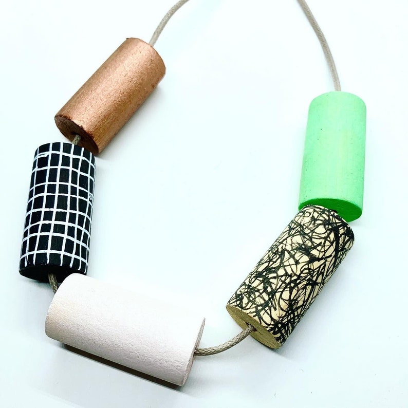 Statement monochrome pattern necklace with hand painted green and pale pink cylinder beads