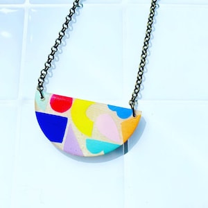 Hand painted geometric pattern resin and plywood necklace