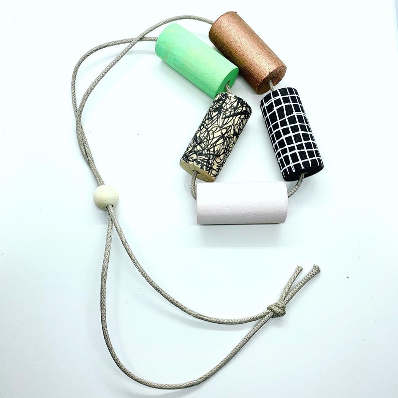 Statement monochrome pattern necklace with hand painted green and pale pink cylinder beads