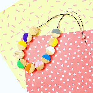 Geometric flat circle bead, minimal style wooden statement necklace in rainbow colours.