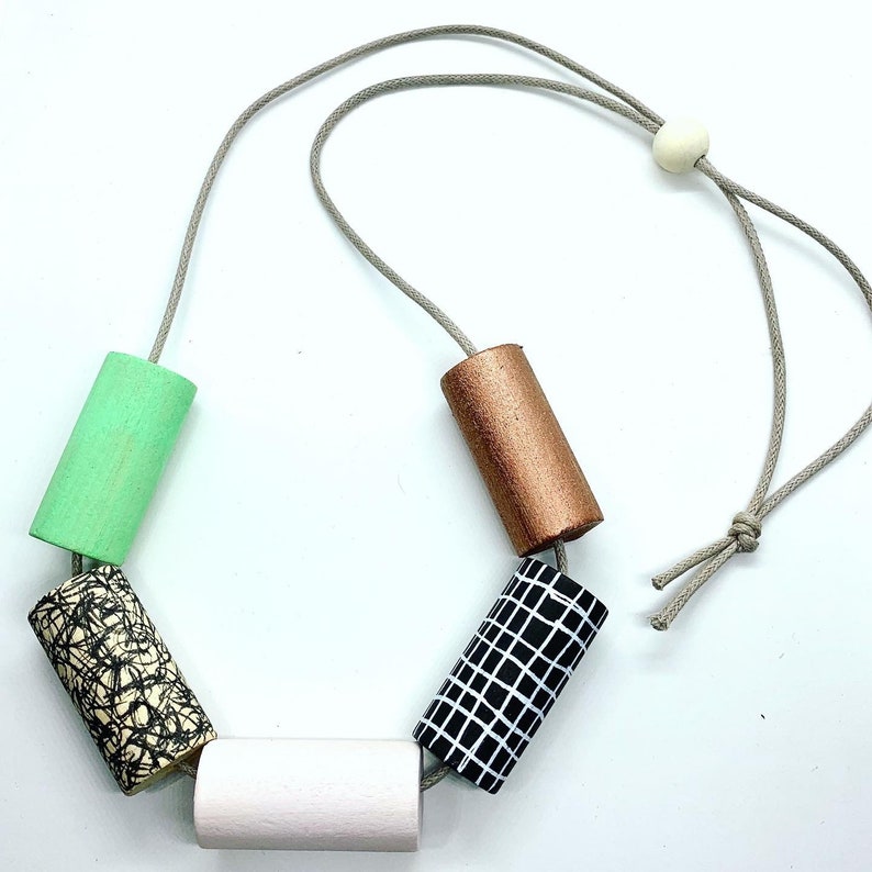 Statement monochrome pattern necklace with hand painted green and pale pink cylinder beads