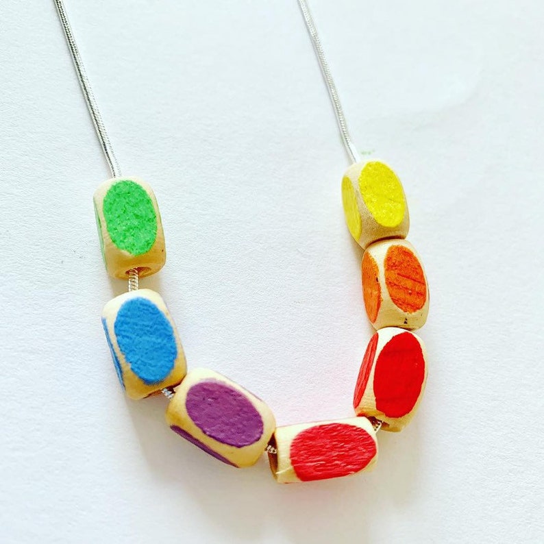 minimal style wooden statement necklace in rainbow colours. Geometric bead