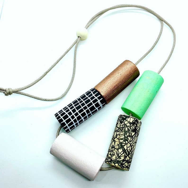 Statement monochrome pattern necklace with hand painted green and pale pink cylinder beads