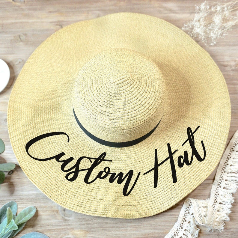 A chic custom bridal sun hat with a monogram, capturing seaside sophistication. This personalized accessory is an exquisite addition to bachelorette festivities and beach