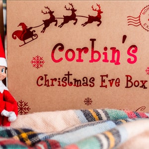zoomed in shot of our christmas eve themed gift  box with child's name and from the recipient, Santa. Stamped north pole express.