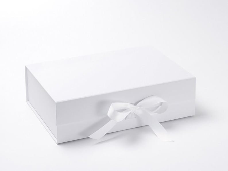 May include: A white gift box with a white satin ribbon tied in a bow.
