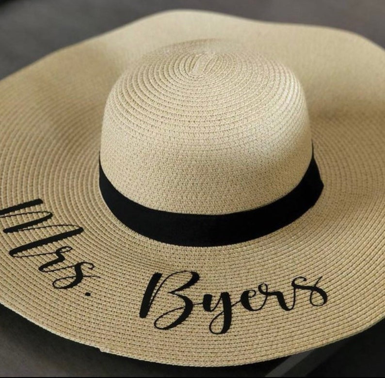 The ultimate bride's sun hat, personalized with care. The floppy brim offers beachside glam, making it a fantastic bridal shower or bachelorette party gift.