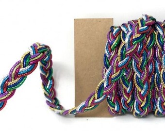 May include: Multicolored braided trim with metallic threads. The trim is woven with shades of pink, green, blue, gold, and silver.