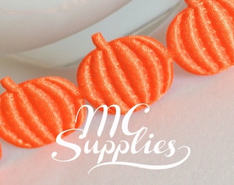 May include: Orange pumpkin-shaped trim with a ruffled texture. The trim is made of fabric and is ideal for adding a festive touch to crafts and decorations.