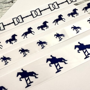 May include: Four white satin ribbons with different equestrian-themed designs. The top ribbon features a repeating pattern of black horse bits. The second ribbon has a repeating pattern of black silhouettes of horses jumping over a fence. The third ribbon has a repeating pattern of black silhouettes of horses running. The fourth ribbon has a repeating pattern of black silhouettes of horses jumping over a fence.