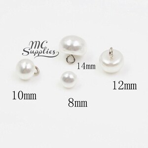 May include: Four white pearl buttons with silver loop closures. The buttons are 8mm, 10mm, 12mm, and 14mm in diameter.