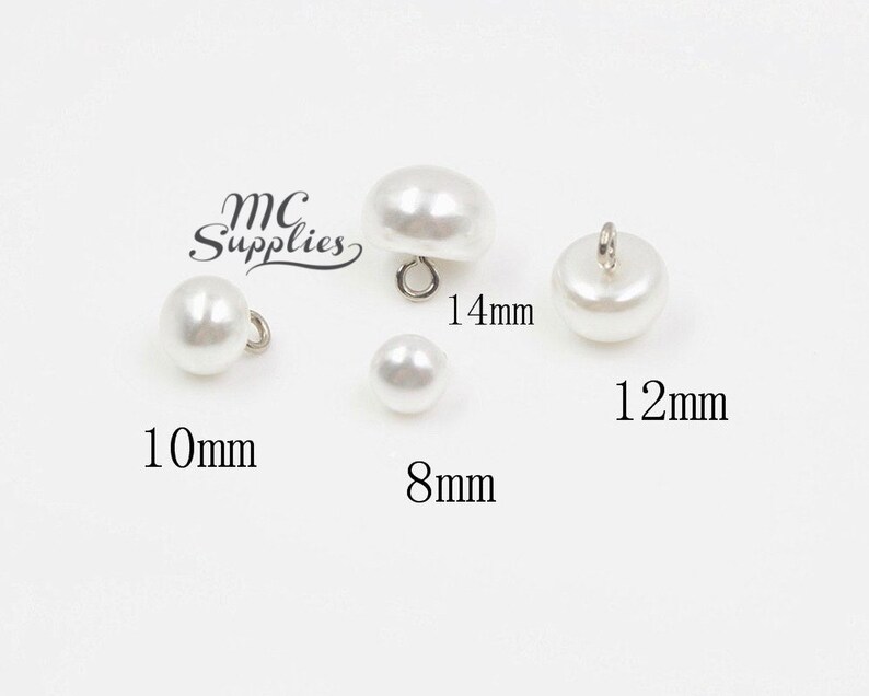 May include: Four white pearl buttons with silver loop closures. The buttons are 8mm, 10mm, 12mm, and 14mm in diameter.