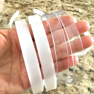 May include: Four plastic headbands, two white and two clear. The headbands are flexible and have a smooth finish.