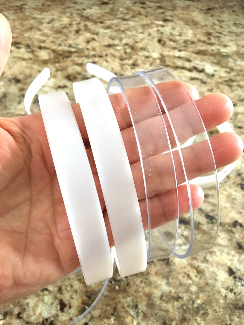 May include: Four plastic headbands, two white and two clear. The headbands are flexible and have a smooth finish.