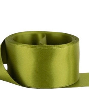 May include: A roll of olive green satin ribbon. The ribbon is smooth and shiny.