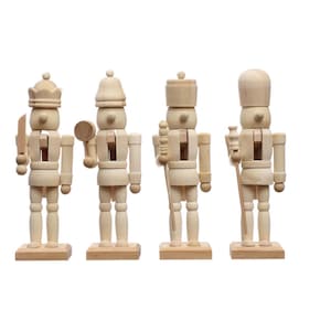 May include: Four unfinished wooden nutcrackers in various poses. Each figure stands on a rectangular base and holds different accessories, including a knife, mallet, staff, and bottle. The nutcrackers are unpainted, showcasing the natural wood grain.