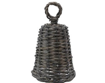 May include: A gray woven bell-shaped decoration with a looped handle. The bell is made of tightly woven wicker, with a flared base and a rounded top. The handle is a simple loop of woven material.