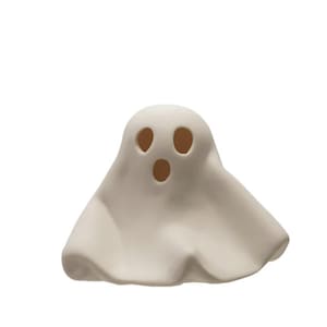 May include: A small, off-white ghost figurine with three circular eye and mouth openings. The ghost has a simple, draped form, suggesting a sheet. This Halloween-themed decoration is suitable for indoor display.