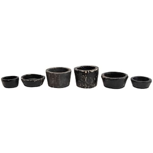 May include: Set of five black ceramic candle holders in various sizes. The holders are distressed and have a rustic look.