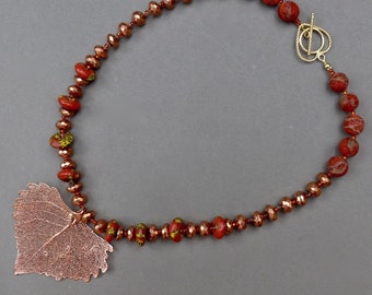 Bright Copper Cottonwood Leaf with Copper and Apple Coral Beads.  Stand out in a crowd.