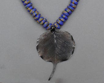 Gunmetal black bhodi leaf with bright blue African trade beads