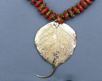 Bold and Bright African Glass Bead Necklace featuring a Gold Bhodi Leaf