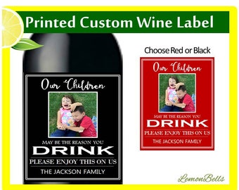 May include: A black and white wine label with a photo of two children and the text "Our Children May Be The Reason You Drink Please Enjoy This On Us The Jackson Family".