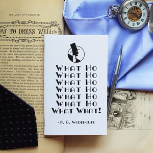 May include: A white book with black text that reads "What Ho What Ho What Ho What Ho What Ho What What!"  - P.G. Wodehouse. The book is surrounded by a blue handkerchief, a pocket watch, a black tie, and a book with the title "The Laws of Etiquette" and the text "How to Dress Well."