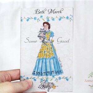 May include: A watercolor illustration of a woman named Beth March holding two kittens. The woman is wearing a blue dress with a yellow floral apron. The text "Some Little Good" is written in cursive at the top of the image and again at the bottom in a wreath of green leaves and red berries.