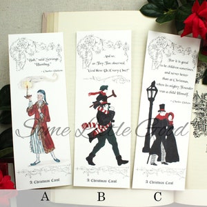 Pode incluir: Tr&ecirc;s marcadores de p&aacute;gina com ilustra&ccedil;&otilde;es e cita&ccedil;&otilde;es de A Christmas Carol de Charles Dickens. O primeiro marcador de p&aacute;gina mostra Scrooge com uma vela, o segundo mostra Tiny Tim e o terceiro mostra um casal caminhando na neve.