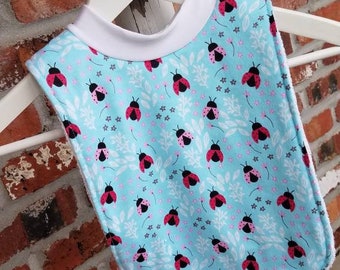 Infant or Toddler Pull Over Bib (Flannel and Terry Cloth) - Ladybugs in Pink on Blue Background