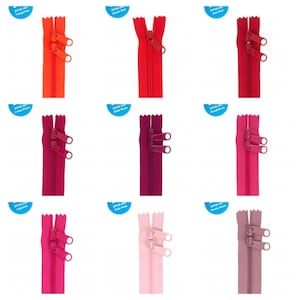 May include: Nine different colors of zipper pulls, each with a different color name label. The colors are: Tangerine, Atom Red, Crazy Plum, Wild Plum, Raspberry, Lipstick, Pale Pink, and Dusty Rose.
