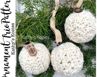May include: Three crocheted white Christmas ornaments with gold glitter accents. The ornaments are hanging from a branch with a brown snowflake embellishment on each.