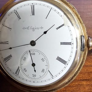 Antique 14 Karat gold Elgin pocket watch with  14 Karat gold watch fob.