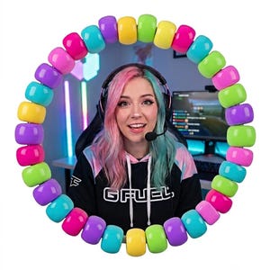 May include: A circular frame composed of vibrant, multi-colored plastic beads in shades of pink, yellow, lime green, purple, and cyan. The beads are arranged in a repeating pattern, creating a bright, glossy border around a central opening.