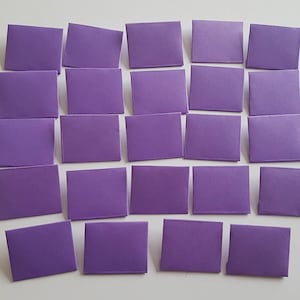 May include: Twenty-four purple paper envelopes arranged in four rows of six. The envelopes are all the same size and shape.