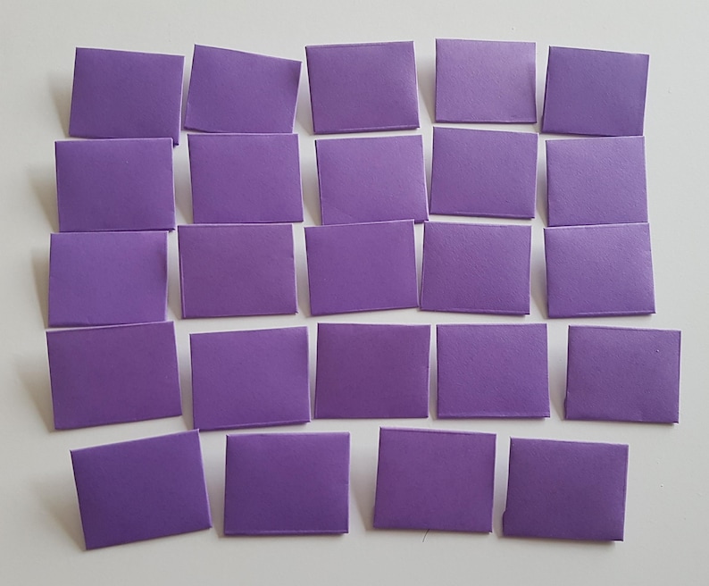May include: Twenty-four purple paper envelopes arranged in four rows of six. The envelopes are all the same size and shape.