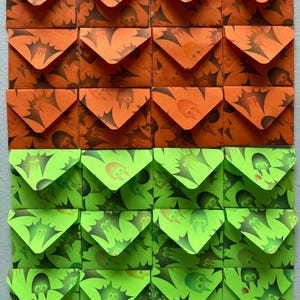 May include: A grid of twenty-four small square envelopes arranged in six rows and four columns. The top three rows feature orange envelopes with a dark brown bat pattern, while the bottom three rows feature lime green envelopes with a dark green bat pattern.