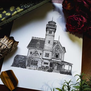 May include: Detailed black and white illustration of a Victorian-style house with a tower, porch, and greenhouse. The artwork is on white paper, with the text "BRIESXBAZAAR" at the bottom. The image is surrounded by books, flowers, and other decorative items.