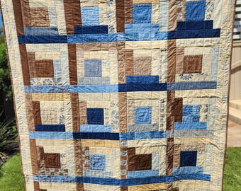 56" by 68" brown, blue and beige sofa throw.  It's a nice quilt/throw to use in any room in your home.