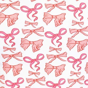May include: A white background with a repeating pattern of pink bows. The bows are drawn in a simple, stylized way, with a single loop and two tails.