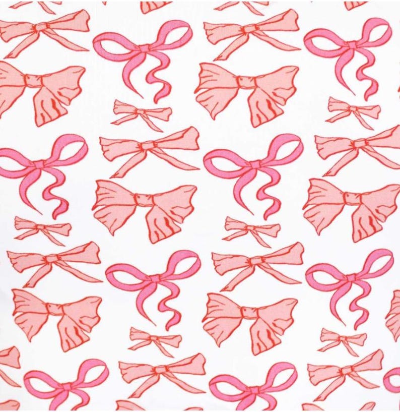 May include: A white background with a repeating pattern of pink bows. The bows are drawn in a simple, stylized way, with a single loop and two tails.