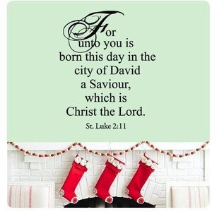 May include: A light green wall sign features the black text: For unto you is born this day in the city of David a Saviour, which is Christ the Lord. St. Luke 2:11. Below, three red stockings with white floral cuffs hang from a beaded garland.