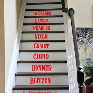 May include: White staircase with the names of Santa's reindeer written in red on each step: On Dasher, Dancer, Prancer, Vixen, Comet, Cupid, Donner, Blitzen, Rudolph.