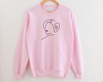 May include: A pink sweatshirt with a black line drawing of Princess Leia's face on the front.