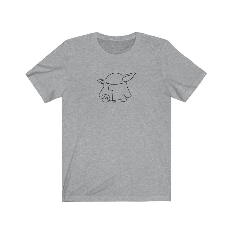 May include: A heather grey t-shirt with a black line drawing of a character from the Star Wars franchise, The Mandalorian.