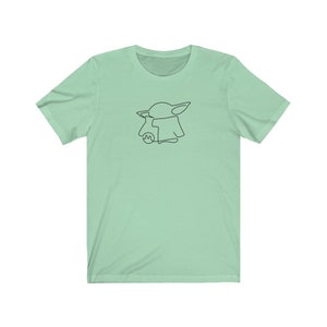 May include: A light green t-shirt with a black line drawing of a character from the Star Wars franchise, The Mandalorian, known as "The Child" or "Baby Yoda".