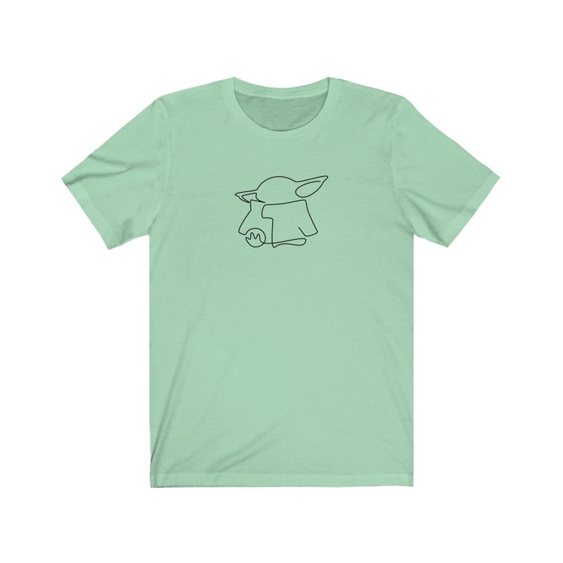 May include: A light green t-shirt with a black line drawing of a character from the Star Wars franchise, The Mandalorian, known as "The Child" or "Baby Yoda".