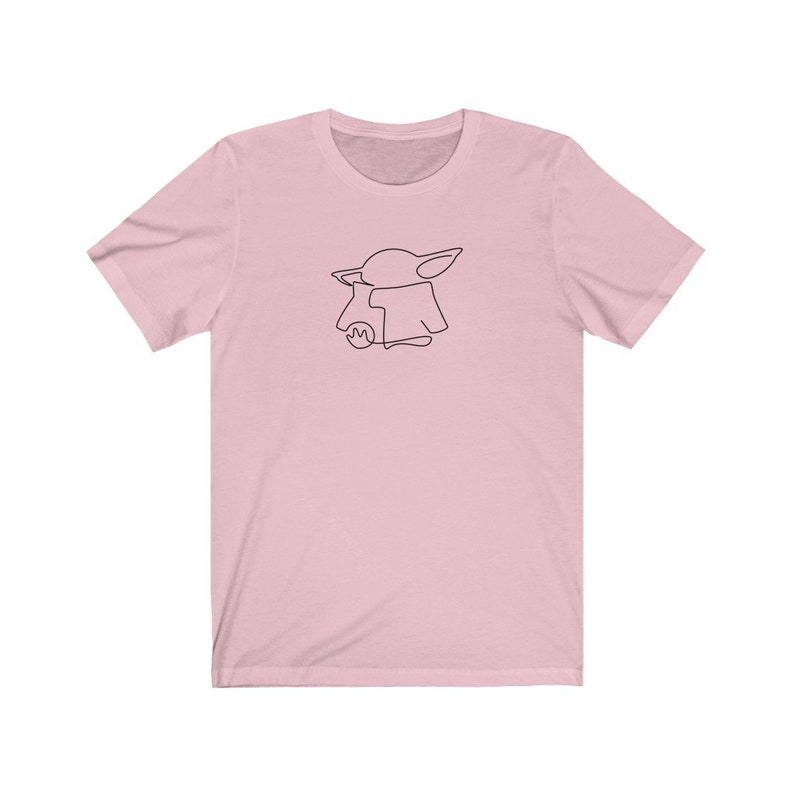 May include: A pink t-shirt with a black line drawing of a character from the Star Wars franchise, The Mandalorian.