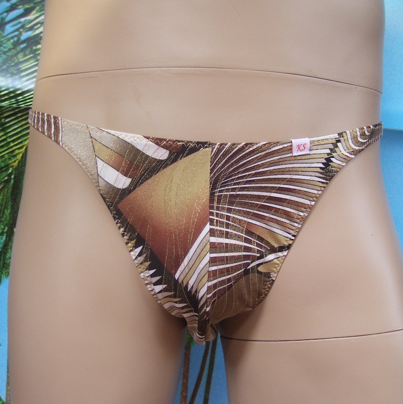 May include: Brown and gold patterned underwear with a white label that says "XS".